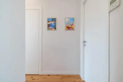 a white room with three pictures on the wall at Soleil de la Buffa - Un joyau central à 3 min des plages in Nice
