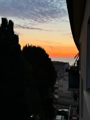 a view of the sunset from a balcony of a building at Anahit in Nice