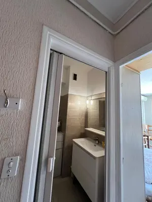 a small bathroom with a sink and a mirror at Studio style vintage à Nice in Nice