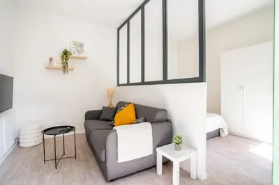 a living room with a couch and a window at 06BZ - Modern apartment in the heart of the port in Nice