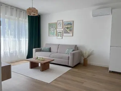a living room with a couch and a coffee table at Appartement - Proche plage & gare in Cagnes-sur-Mer