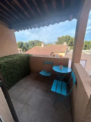 a small patio with a blue table on a balcony at Calm#Child friendly#Home#Beach#Airport in Saint-Laurent-du-Var