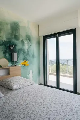 a bedroom with a bed and a large window at Prestigieuse Villa De Crémat Nice in Nice