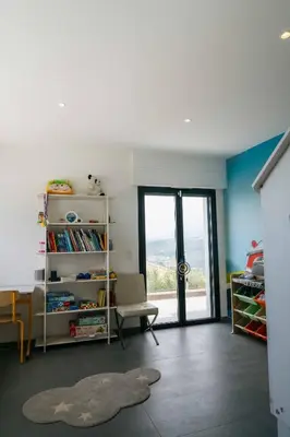 a living room with a book shelf and a window at Prestigieuse Villa De Crémat Nice in Nice