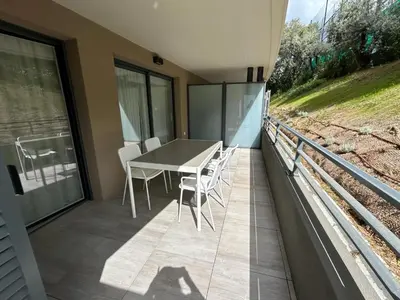 a patio with a table and chairs on a balcony at Fabron Hills By Avecoeur in Nice
