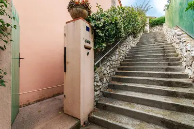 a set of stairs with a plant on top of it at ROMANTIC VILLA VI4412 By Riviera Holiday Homes in Villefranche-sur-Mer