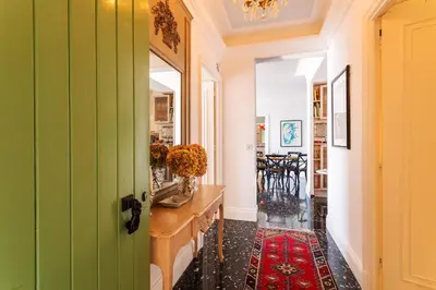a green door in a hallway with a table and chairs at ROMANTIC VILLA VI4412 By Riviera Holiday Homes in Villefranche-sur-Mer