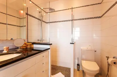 a bathroom with a toilet and a sink and a mirror at ROMANTIC VILLA VI4412 By Riviera Holiday Homes in Villefranche-sur-Mer
