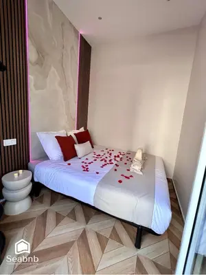 a bedroom with a bed with red roses on it at Luxurious Apartment - Seaside - Spa Bath - WiFi - AC in Nice