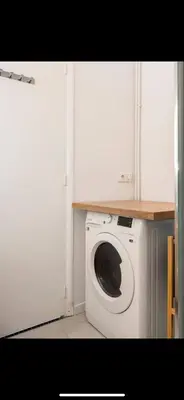 a washer and dryer in a corner of a room at Studio de luxe au cœur de Nice in Nice