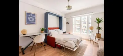 a bedroom with a bed and a desk in it at Studio de luxe au cœur de Nice in Nice