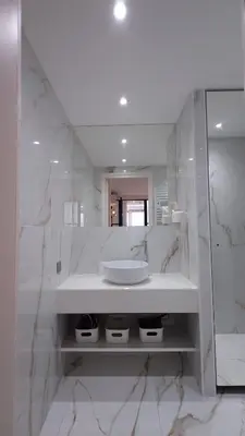 a white bathroom with a sink and a mirror at Club Inn Appartement in Nice