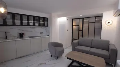 a living room with a couch and a chair at Club Inn Appartement in Nice