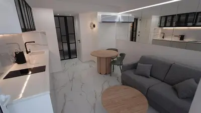 a living room with a couch and a table at Club Inn Appartement in Nice
