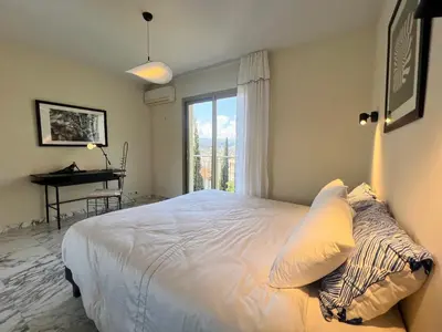 a bedroom with a bed with a window and a piano at ApartHotel Riviera - TERRASSE DES AGAVES - Amazing Sea View Nice Côte d'Azur in Nice