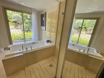 a large bathroom with a tub and a window at ApartHotel Riviera - TERRASSE DES AGAVES - Amazing Sea View Nice Côte d'Azur in Nice