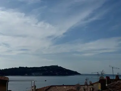 a view of a body of water with an island at The Seaside Serenity -NEW AC equipped - Calm with Bay View - Heart of Villefranche in Villefranche-sur-Mer