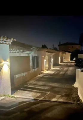 a row of buildings lit up at night at DOMAINE LOU BEL AZUR - Harmonie in Saint-Laurent-du-Var