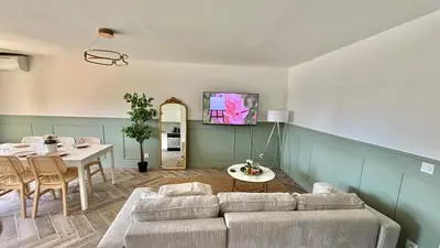 a living room with a couch and a table at Modern & Cosy 3 Bedrooms train tramway in Nice
