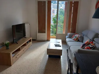 a living room with a couch and a tv at Appartement cosy Nice in Nice