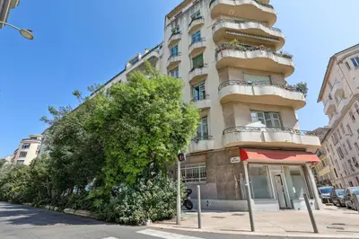 a tall building with a tree in front of it at Lavie Maison Hot Tub Seaside Flat in Nice