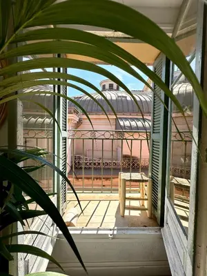 a view of a balcony from a window with a table at Superbe duplex entre le Vieux Nice et la Prom in Nice