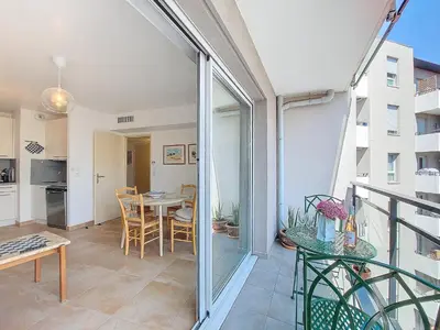 a balcony with a table and a dining room at Nestor&Jeeves - VAGUE AZUR - Balcony - Central in Nice