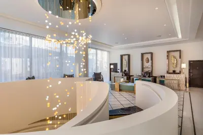 a lobby with a chandelier and a living room at Maison Albar - Le Victoria in Nice