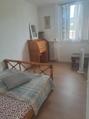 a bedroom with a bed and a desk and a piano at La bella vista in Nice
