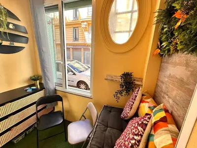 a small room with a couch and a window at Studio Coeur Delille FSHH in Nice