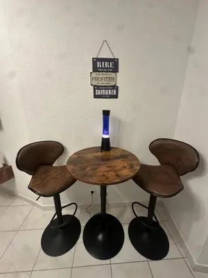 a table with four chairs and a wine glass on it at Jolie deux pièces au cœur de Nice in Nice