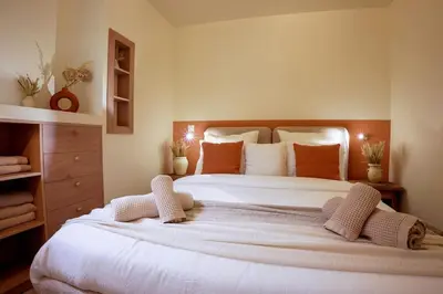 a bedroom with a large white bed with orange pillows at Nice - Amazing flat to 10 min to sea - Garden in Nice