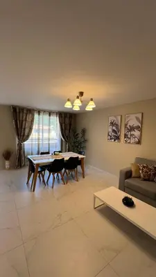 a living room with a table and a couch at Super logement - Mer à 5 min à pieds ! in Nice