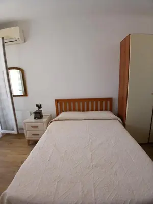 a bedroom with a large bed with a wooden headboard at Maria in Nice