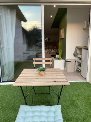 a wooden table sitting on the grass in a yard at La chambre de Cleron in Saint-Laurent-du-Var