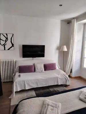 a bedroom with a large bed with purple pillows at Movida in Nice
