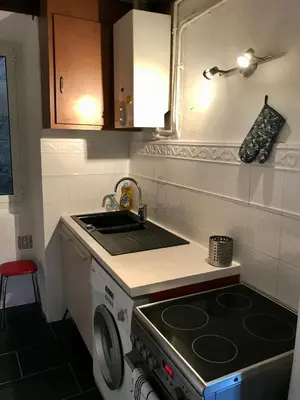 a small kitchen with a stove and a sink at Petit cocon in Villefranche-sur-Mer