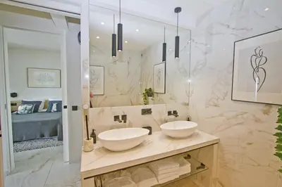 a bathroom with two white sinks on a counter at Luxury Flat Beachfront Nice in Nice