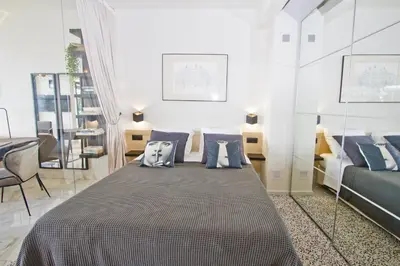 a bedroom with a bed with pillows on it at Luxury Flat Beachfront Nice in Nice
