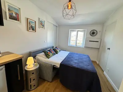 a small bedroom with a bed and a window at APartHotel Riviera - COCON DE LA LIBERTE - Grimaldi - Promenade des Anglais in Nice