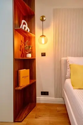 a bedroom with a book shelf next to a bed at Nice Mer & Cours Saleya Serenity Luxury - 2 suites in Nice