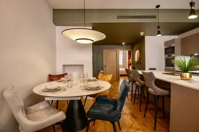a kitchen and dining room with a table and chairs at Nice Mer & Cours Saleya Serenity Luxury - 2 suites in Nice