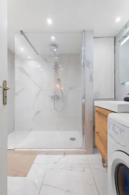 a bathroom with a shower with a glass door at Nice Renting - 3 MASSENA - Chic Escape Luxury Duplex Place Massena in Nice