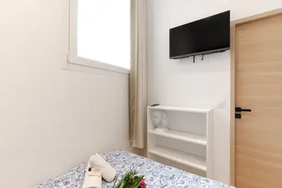 a bedroom with a bed and a tv on the wall at Lavie Maison Sauna and Hot Tub Seaside in Nice