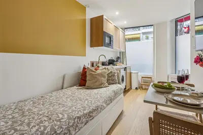 a bedroom with a bed and a dining room with a table at Lavie Maison Hot Tub Seaside Studio in Nice