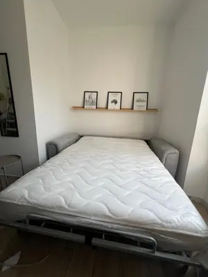 a bed in a room with three pictures on the wall at Studio Sydney - Jean Médecin - LA RIVIERA LCD in Nice