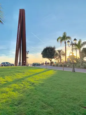 a grassy field with palm trees and a monument at Studio Sydney - Jean Médecin - LA RIVIERA LCD in Nice