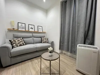 a living room with a couch and a table at Studio Sydney - Jean Médecin - LA RIVIERA LCD in Nice