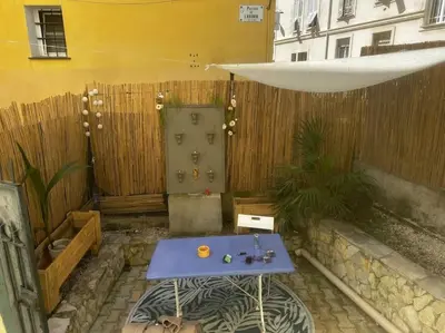 a blue table in front of a wooden fence at Chez Yaya in Nice