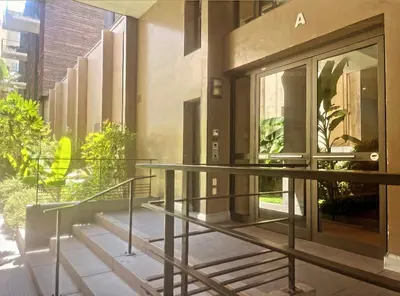a glass entrance to a building with a revolving door at Nice SuiteMarie Carre d'or in Nice